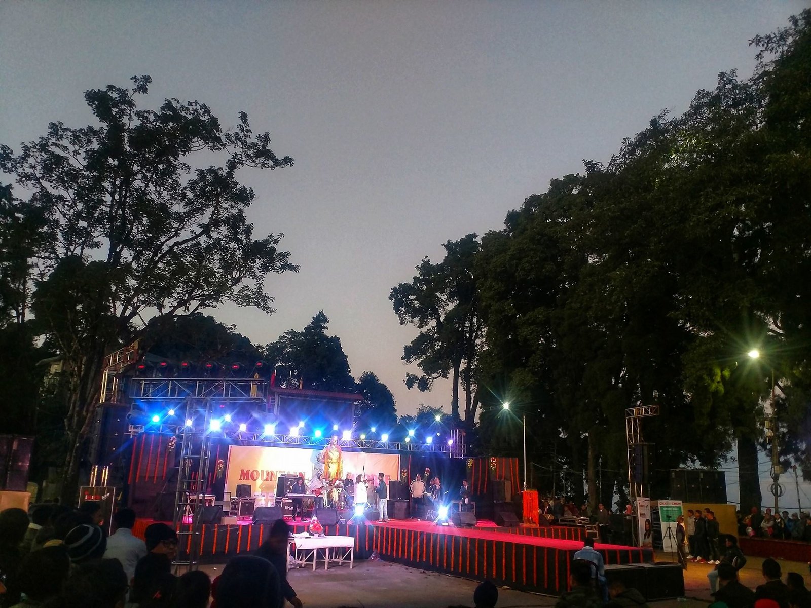 Stage show lit up at dusk during an evening programme on Mall Road Darjeeling