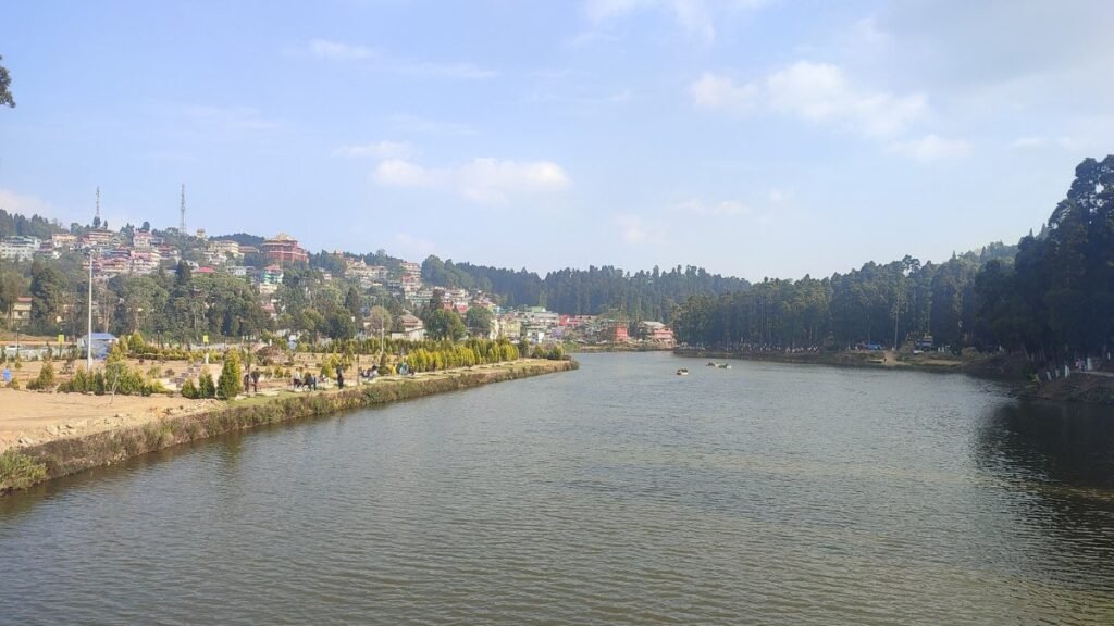 Sumendu Lake in Mirik with pine-covered hills and the town on the far bank